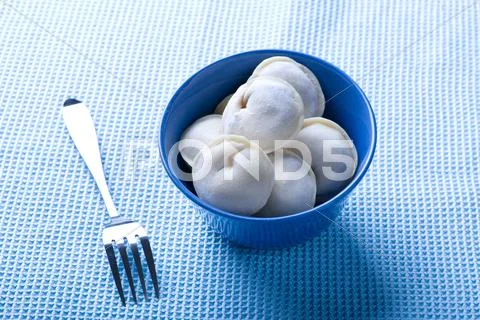 Ravioli on blue close up Stock Photos