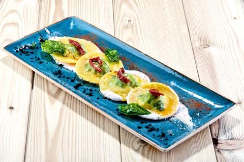 A ravioli sitting on top of a wooden table Stock Photos