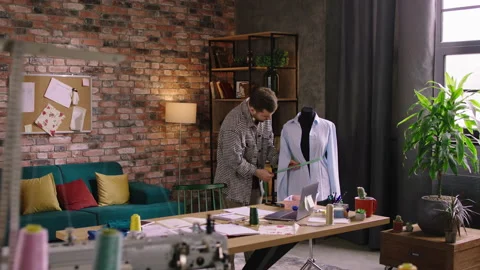 Ravishing looking man, nicely dressed is doing up measurements on a mannequin Stock Footage 194272070