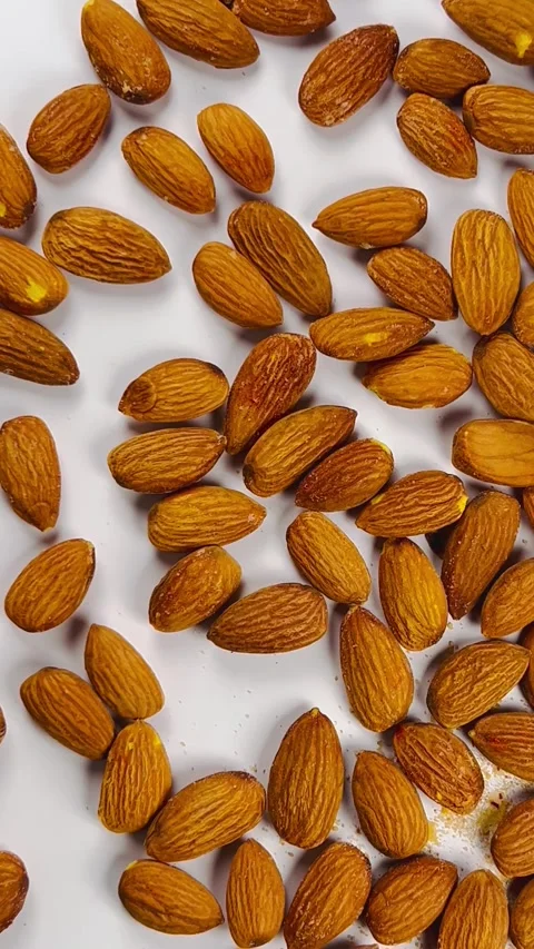 Raw almond nuts on white background top view Stock Footage 336471327