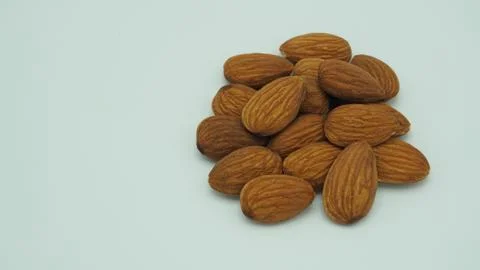 Raw almonds close up put on white background. Stock Photos