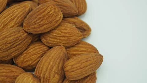 Raw almonds close up put on white background. Stock Photos
