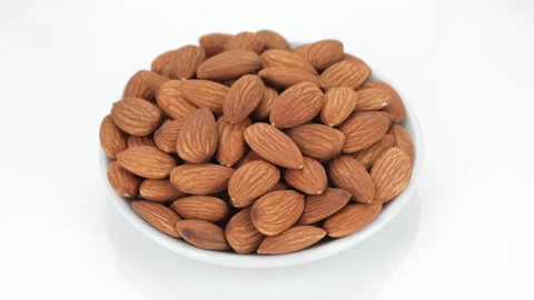 Raw almonds isolated on white background, rotation. Healthy food concept Stock Footage 153069495