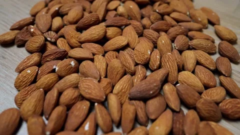 Raw Almonds on Wooden Surface Stock Footage 320726841