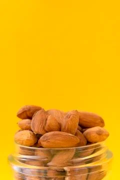 Raw almonds on a yellow background. Stock-Fotos