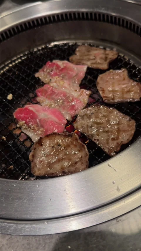 Raw and Cooked Beef Sizzling on Korean BBQ Grill Stock Footage 346043101