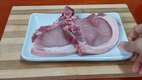 Raw and Fresh Pork Chops in a Plate Stock Footage 235499258