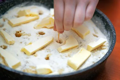 Raw apple pie being prepared, showcasing the process of poking holes in the c Stock Photos