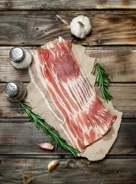 Raw bacon on paper. Stock Photos