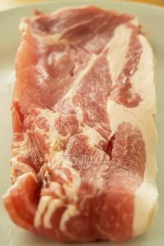 Raw bacon on a plate Stock Photos