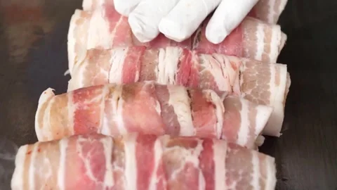 Raw Bacon Wrapped Meat Rolls Placed on a Pan for Cooking - Close-Up Shot Video stock 343588016