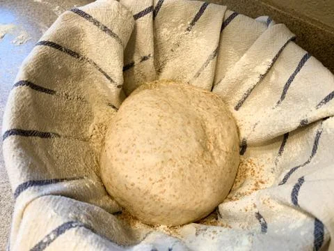 Raw Ball of Bread Dough on a Kitchen Towel Sprinkled with White Flour Stock Photos