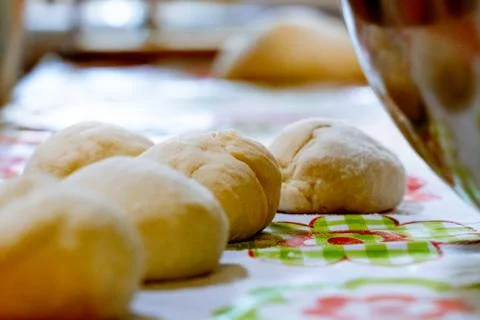 Raw balls of bread in the kitchen table Stock Photos