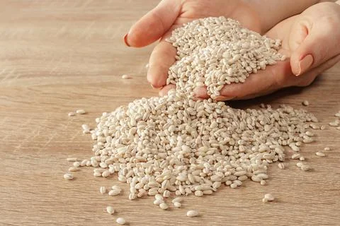Raw barley in hands Stock Photos