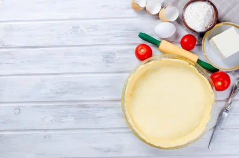 Raw base of pastry for baking in a baking dish Stock Photos