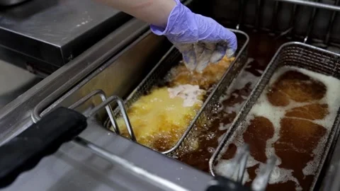Raw Battered Chicken Dipped into Boiling Oil for Frying Stock Footage 288575380
