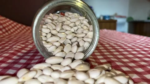 Raw beans spread out on table out of jar Video stock 222198360