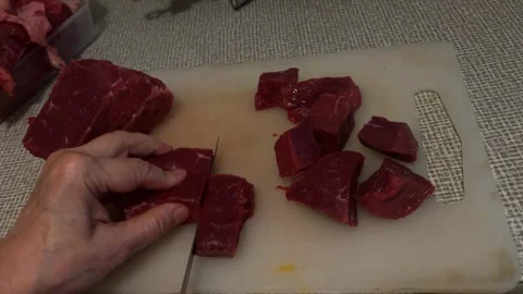 Raw beef being sliced on cutting board, showing food preparation and culina.. Stock Footage 344422285