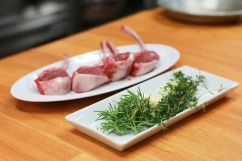 Raw beef bone rib-eye steak with onion, garlic and garnish ready to cook. Stock Photos