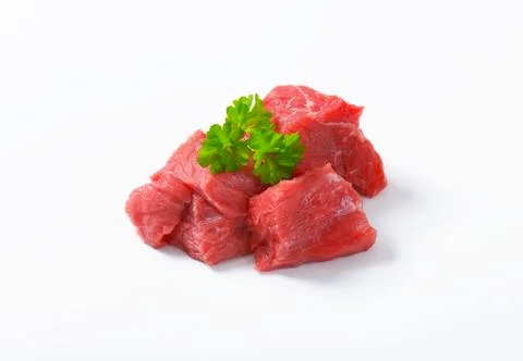 Raw beef cut into cubes Stock Photos
