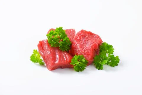 Raw beef cut into cubes Stock Photos