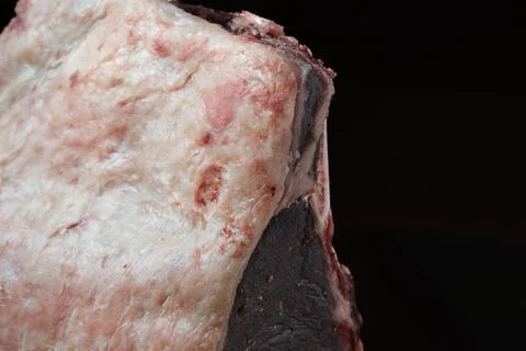 Raw beef cut, fatty surface, rich marbling Fotos de archivo