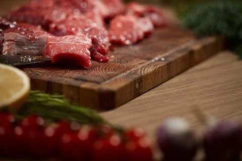 Raw beef cuts on rustic wooden board 写真素材