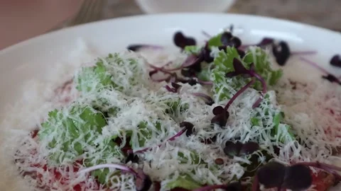 Raw beef dish garnished with parmesan cheese Stock Footage 228408189