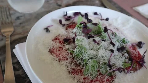 Raw beef dish garnished with parmesan cheese Stock Footage 228408249