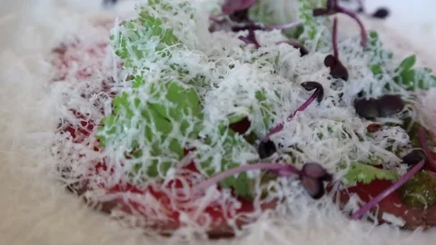 Raw beef dish garnished with parmesan cheese Stock Footage 228408488