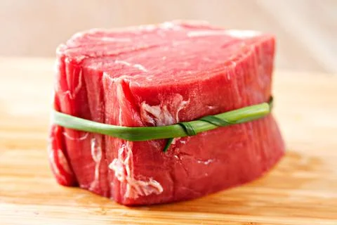 Raw beef filet Mignon steak on a wooden Board. Stock Photos
