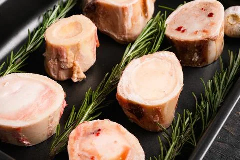 Raw beef marrow bones, on black wooden table background Stock Photos