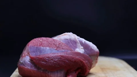 Raw beef meat on a black background Stock Footage 126573397