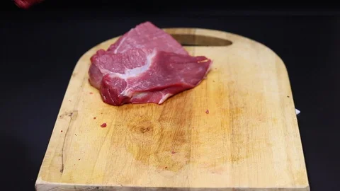 Raw beef meat on a black background Stock Footage 128283636
