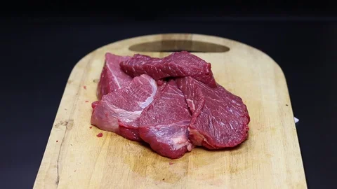 Raw beef meat on a black background Stock Footage 128283841