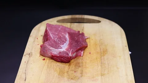 Raw beef meat on a black background Stock Footage 128283851