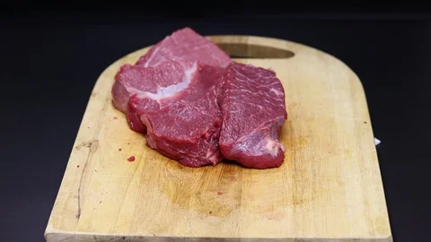 Raw beef meat on a black background Stock Footage 128283888
