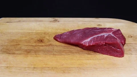 Raw beef meat on a black background Stock Footage 128284086