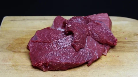 Raw beef meat on a black background Stock Footage 128284168