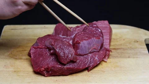 Raw beef meat on a black background Stock Footage 128284295