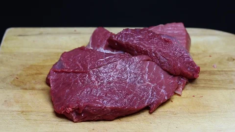 Raw beef meat on a black background Stock Footage 128284390