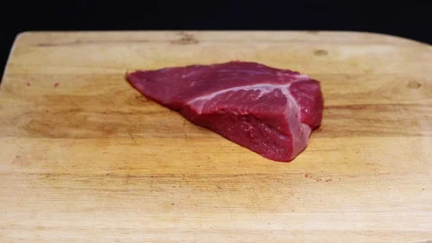 Raw beef meat on a black background Stock Footage 128284736