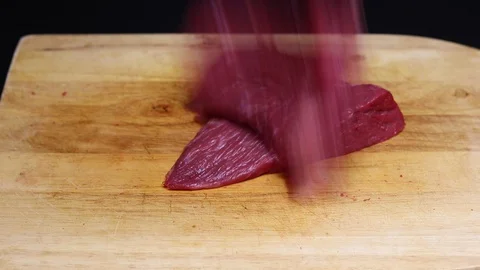 Raw beef meat on a black background Stock Footage 128284855