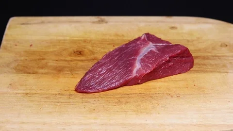 Raw beef meat on a black background Stock Footage 128284963
