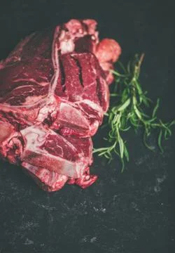 Raw beef meat t-bone steaks with rosemary, copy space Stock Photos