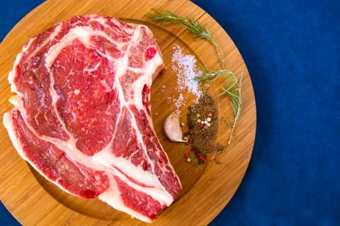 Raw beef meat on the table, spices and Rosemary, Rib eye steak ingredients. P Stock Photos