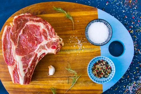 Raw beef meat on the table, spices and Rosemary, Rib eye steak ingredients. P Stock Photos