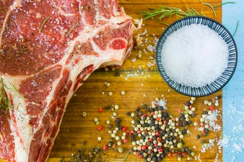 Raw beef meat on the table, spices and Rosemary, Rib eye steak ingredients. P Stock Photos
