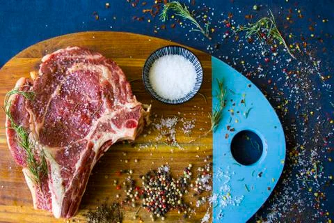 Raw beef meat on the table, spices and Rosemary, Rib eye steak ingredients. P Stock Photos