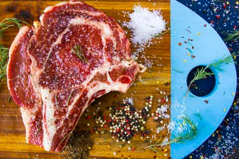 Raw beef meat on the table, spices and Rosemary, Rib eye steak ingredients. P Stock Photos